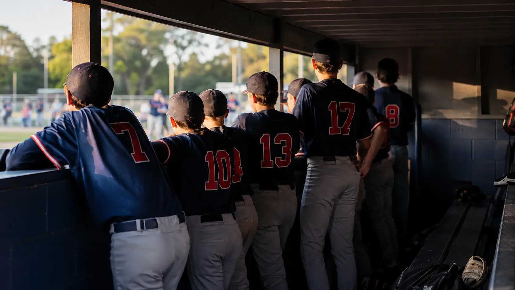 Youth baseball players in a dugout during a 13U national tournament